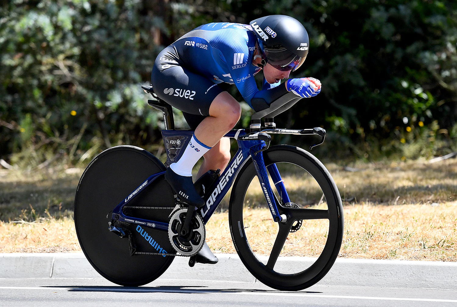 Cyclist racing in time trial on road track