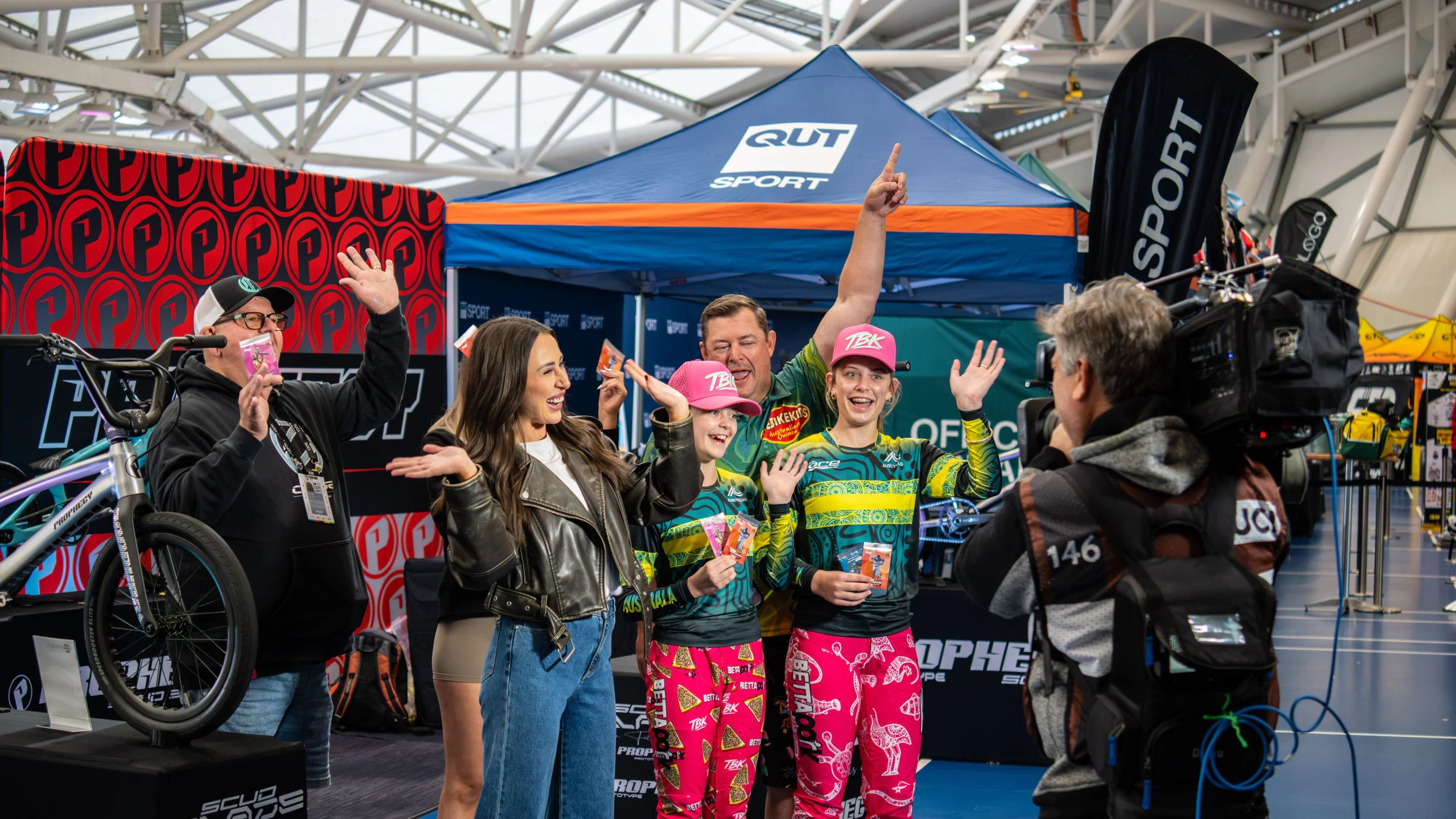 The Today Show films a segment at the UCI BMX Racing World Championships with Team Australia BMX Challenge riders in front of a QUT Sport expo tent