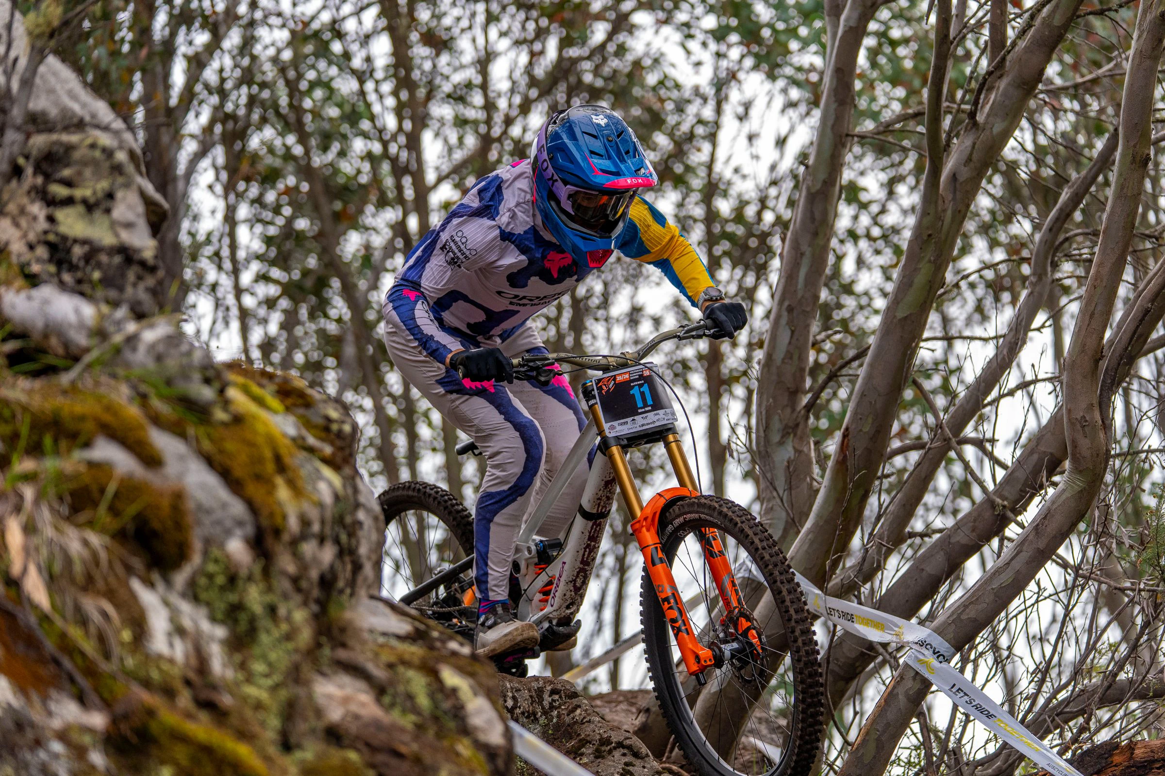 A downhill mountain bike rider races during the Victorian Downhill Series at Falls Creek 2026