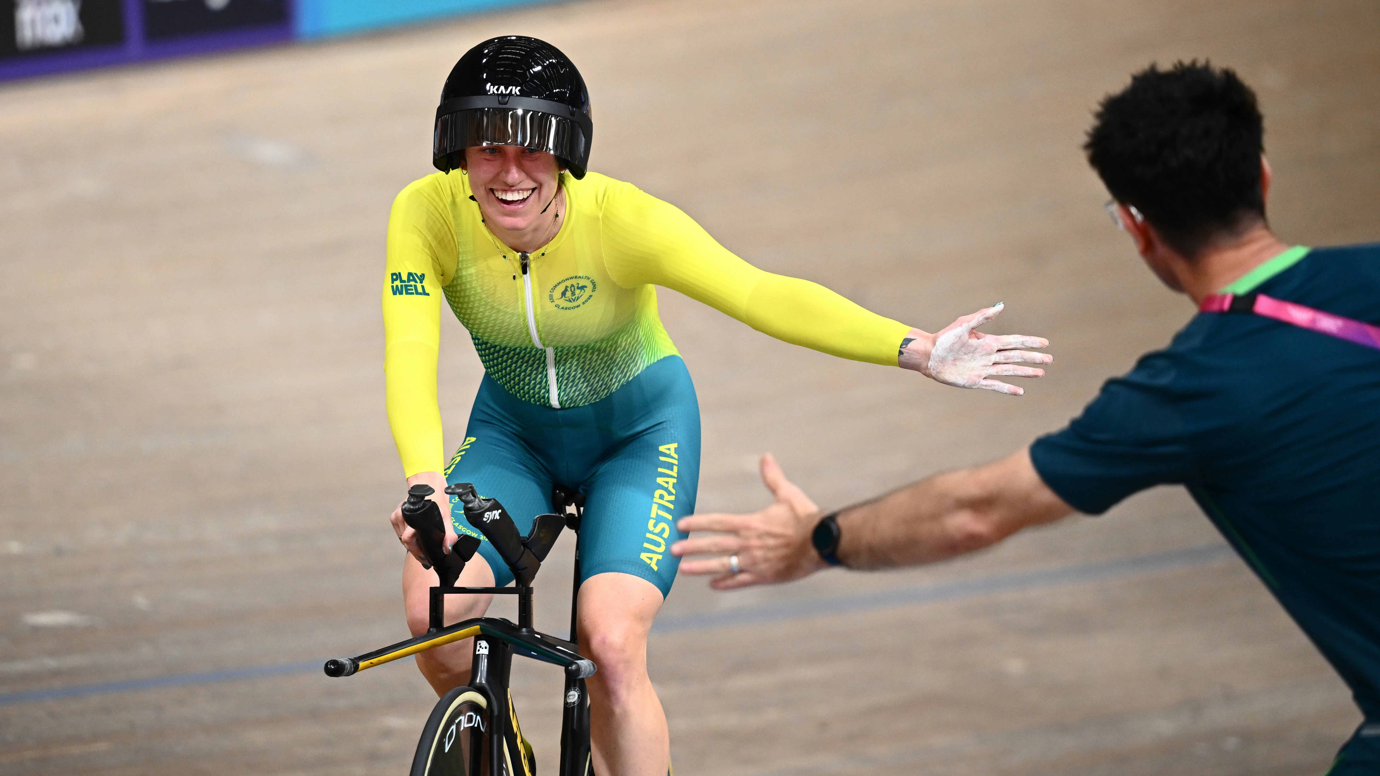 Tara Neyland of Australia celebrates with a high-five after winning the Women's C4−C5 1km time trial at the Glasgow 2026 Commonwealth Games