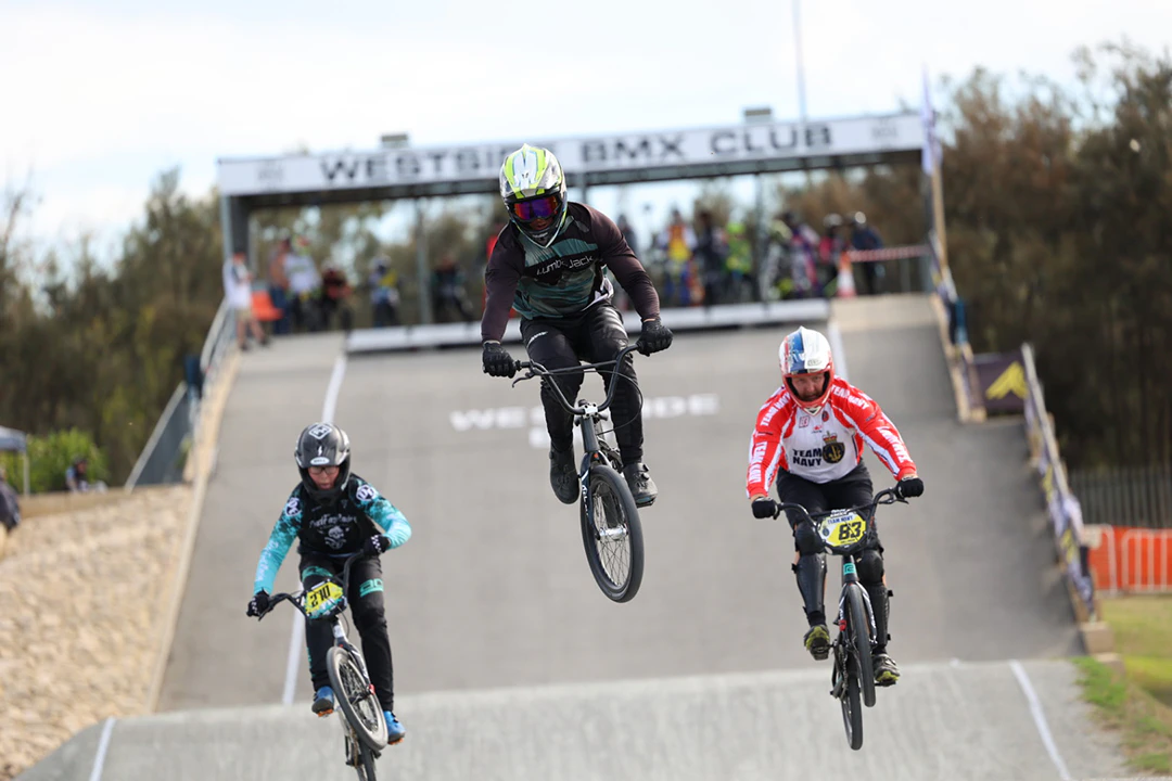 BMX riders racing through course at Westside BMX club