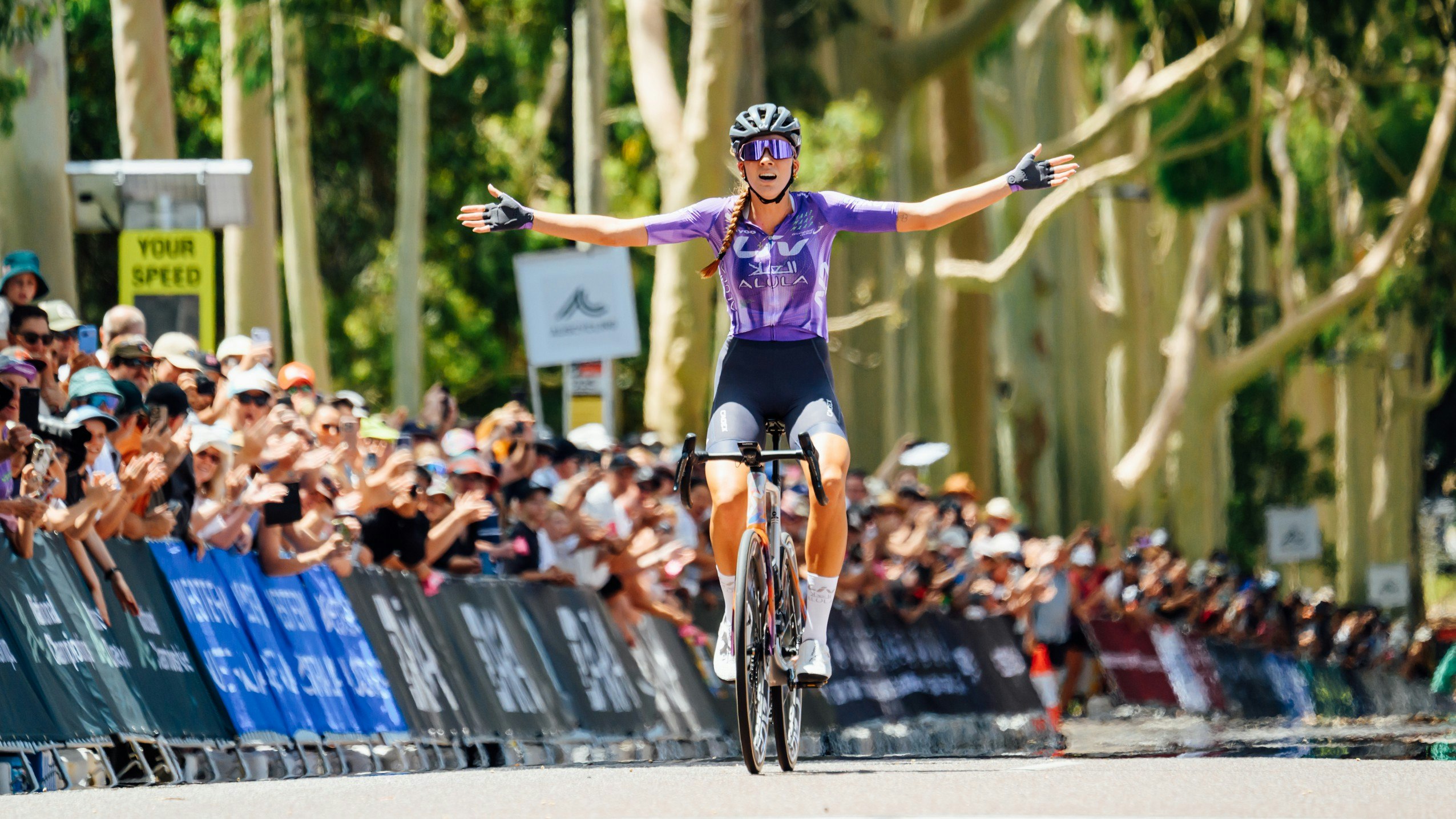 Mackenzie Coupland celebrates victory in the elite women road race at the 2026 Westbridge Funds Road National Championships in Kings Park, Perth, Western Australia